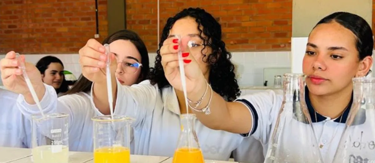Alunas fazendo um experimento no laboratório de ciências